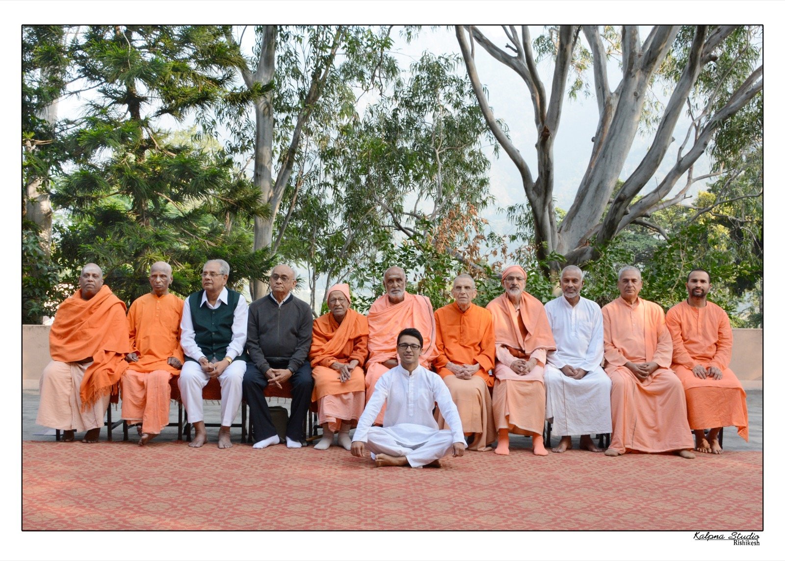 Ashwin seated with monks at Sivananda Ashram in Rishikesh